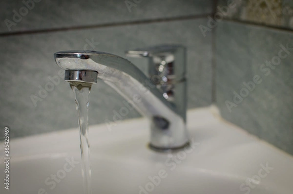 Obraz water flowing from faucet in bathroom