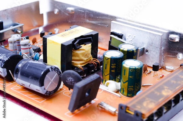 Obraz Power supply for LED strip. Power supply unit view from noodle. Capacitors, power supply components in close-up
