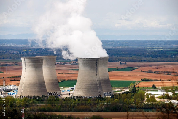 Obraz smiking cooling towers of a nuclear power plant in the coutryside
