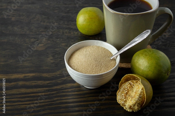 Obraz dried monk fruit, luo han guo, and monk fruit sugar crystals accompanied with a cup of tea or coffee