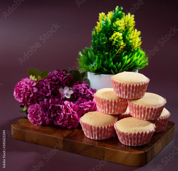 Fototapeta Ancient egg cakes in paper cup with purple background