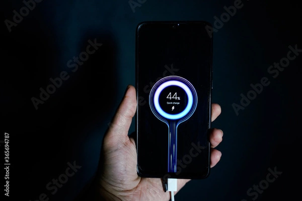 Obraz holding charging smartphone quick charge fast charge