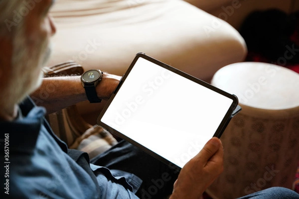 Obraz old man white hair with smart watch using pro tablet
