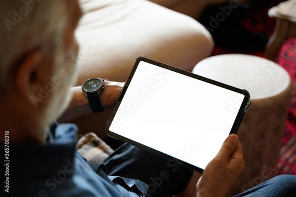 Obraz old man white hair with smart watch using pro tablet