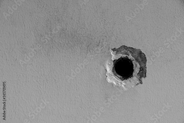 Fototapeta Crack of the the faucet hole in concrete wall.Black and white cement wall.