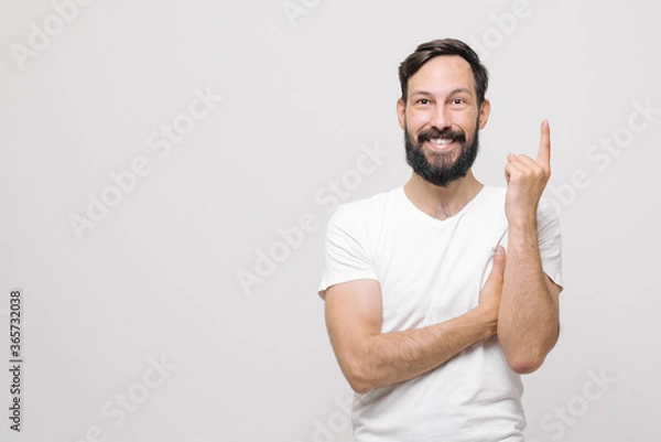 Fototapeta  a young man came up with an idea and holds his index finger up