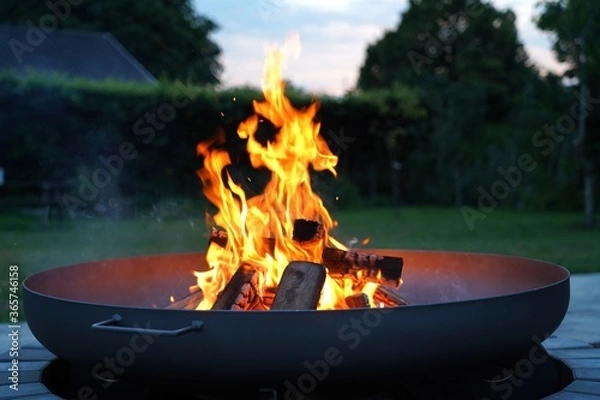 Obraz Iron fire pit and burning fire in a garden .  Campfire ,  close up image .