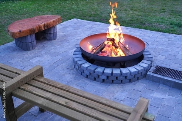 Obraz Iron fire pit and burning fire in fire place  a garden .