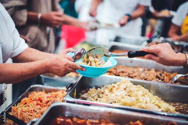 Fototapeta The concept of feeding : Receiving food for the poor from volunteers