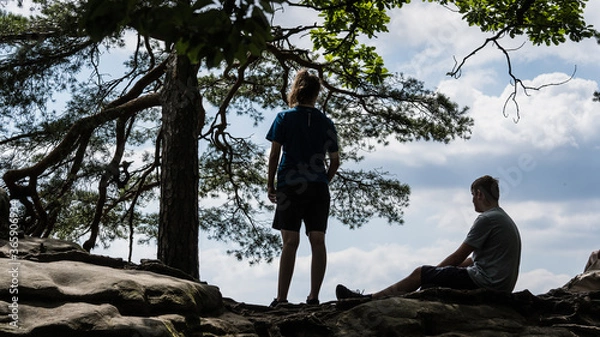 Fototapeta Silhouette of two teenager in the mountains