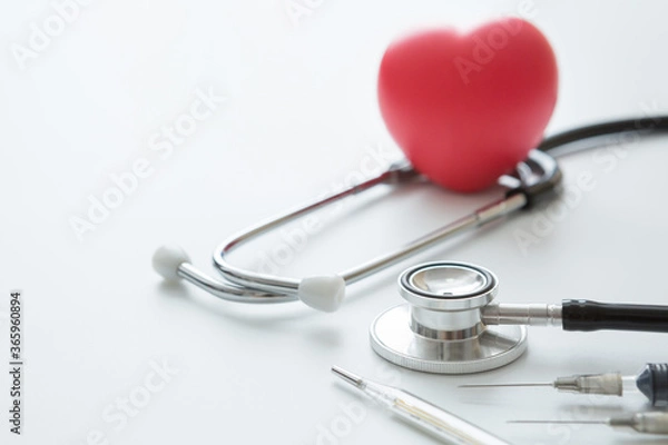 Fototapeta Selective focus of Heart shaped squeeze ball for hand muscle exercise stethoscope , Syringes and thermometer  on a white background and copy space