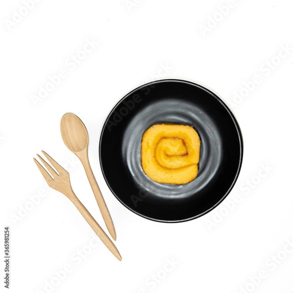 Obraz wooden spoon and black plate with a Jam Rolls