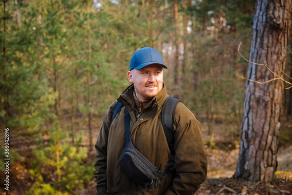 Obraz Handsome traveller with smiley face in the heart of forest