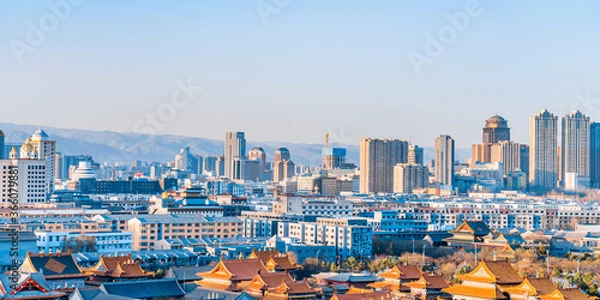 Fototapeta Dazhao Temple in Hohhot, Inner Mongolia, China and the distant view of tall buildings in the distance