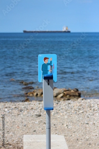 Fototapeta The picture of Alcohol gel Pick up point ,staying on the beach in summer time In public areas,Italy beach