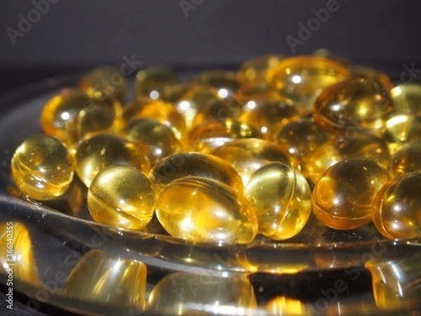 Obraz Trans-lucid cod liver oil pills under colourful light