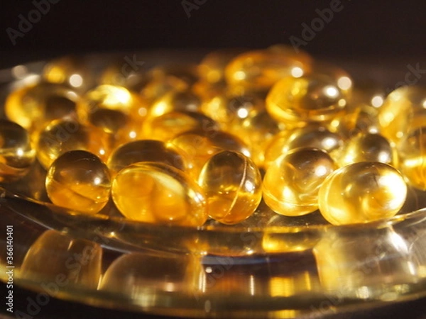 Obraz Trans-lucid cod liver oil pills under colourful light