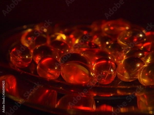 Obraz Trans-lucid cod liver oil pills under colourful light