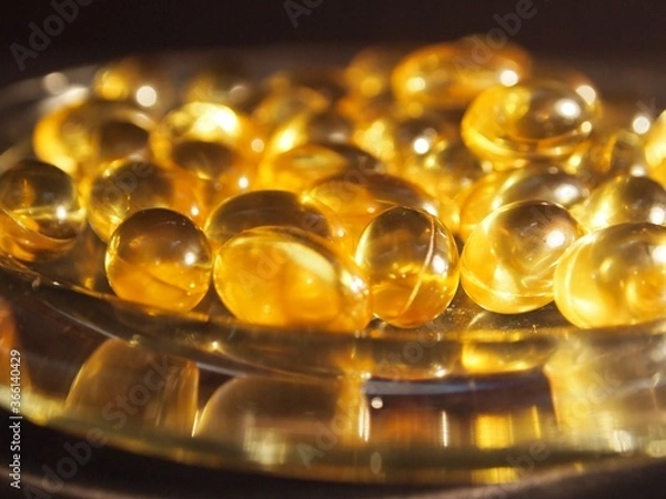 Obraz Trans-lucid cod liver oil pills under colourful light