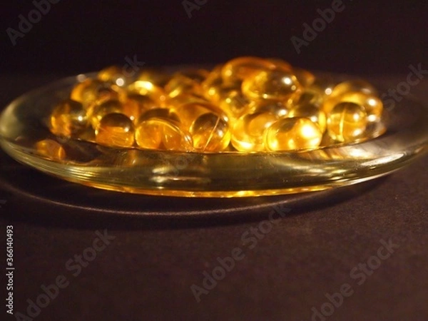 Obraz Trans-lucid cod liver oil pills under colourful light