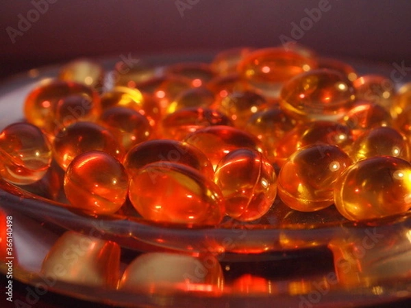 Obraz Trans-lucid cod liver oil pills under colourful light