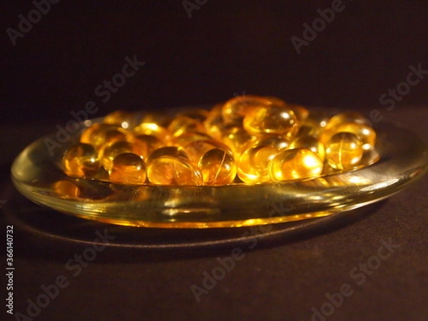 Obraz Trans-lucid cod liver oil pills under colourful light
