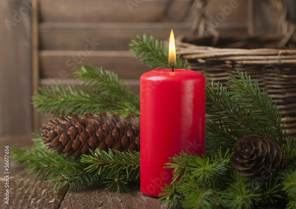Fototapeta Christmas red candle and spruce branches