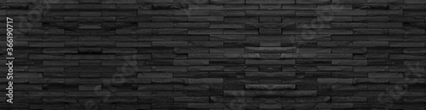 Fototapeta panorama czarna ceglana ściana z ciemnego kamienia tekstury i tła, panoramiczny kamienny szeroki obraz.