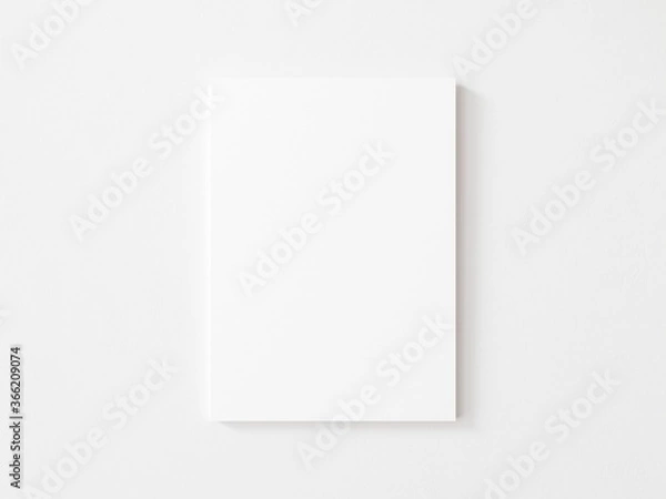 Fototapeta Empty vertical canvas frame on white wall. 3d illustration.