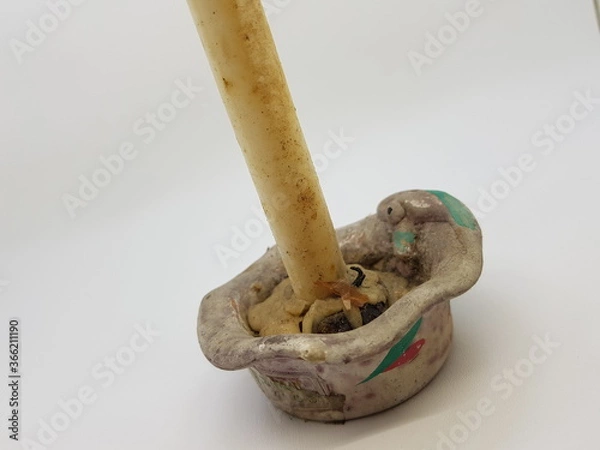 Obraz Candle in a candlestick, vintage candle holder on a white background