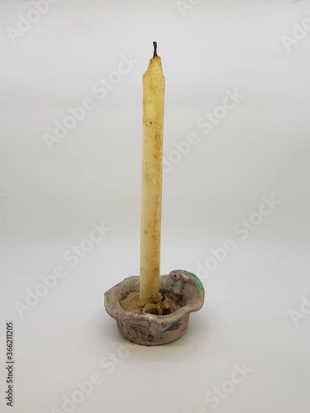 Obraz Candle in a candlestick, vintage candle holder on a white background
