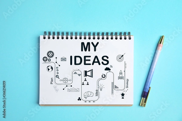 Fototapeta Notebook with words MY IDEAS and scheme on light blue background, top view