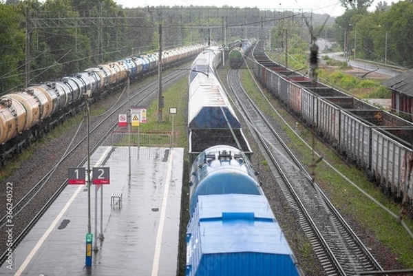 Obraz Railway station in rainy weather with standing freight cars and tanks.