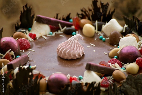 Fototapeta chocolate cake, top view of the decoration, close-up