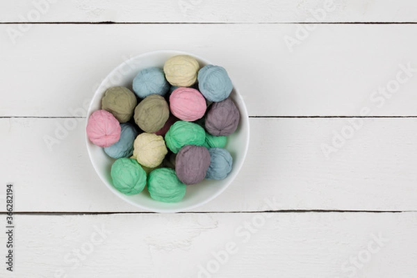 Fototapeta Colored nuts in a bowl on a white background
