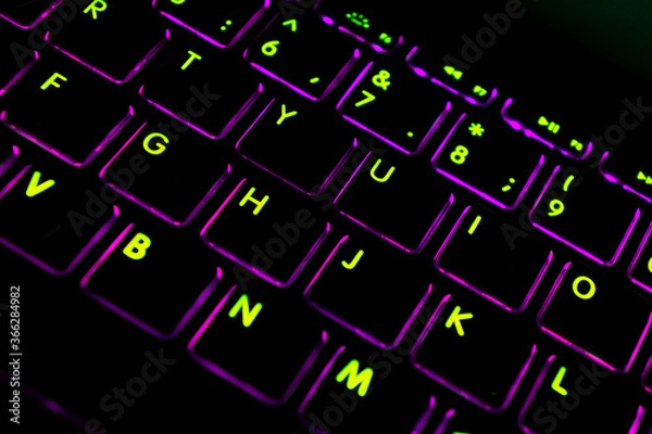 Fototapeta Close up view of a modern laptop computer keyboard key with pink buttonss. Pc computer keyboard close up