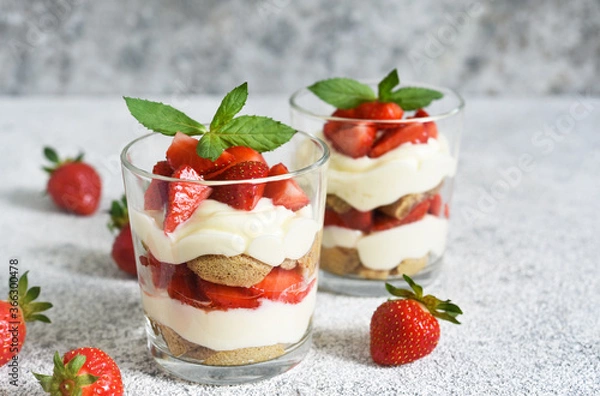 Fototapeta Strawberry tiramisu in a glass on a concrete background. Classic Italian dessert.