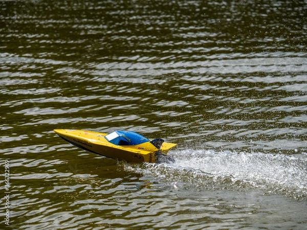 Obraz RC controlled speedboat model on lake. Active summer vacation for school child.