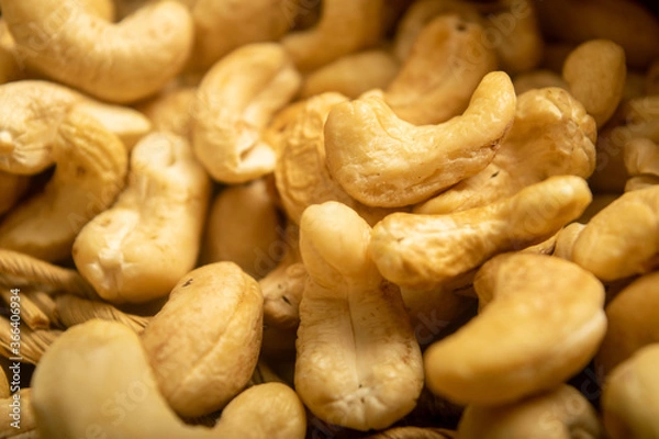 Fototapeta Cashew nuts scattered surface texture. Close up.