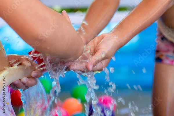 Fototapeta 3-4 year-old girls, ASEAN people playing in the inflatable pool