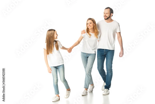 Fototapeta happy casual family holding hands while walking isolated on white
