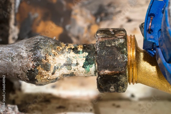 Obraz old lead pipe to replace by professional plumber due to health hazard