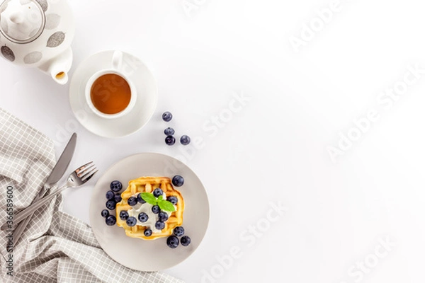 Obraz Homemade belgian waffles on served table on white background top view mockup