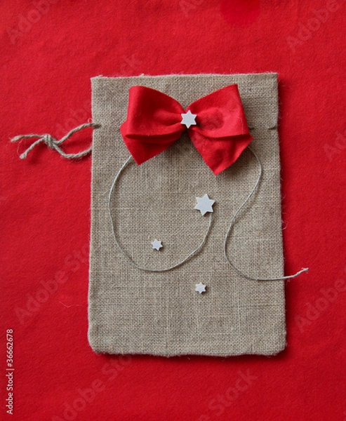 Fototapeta Jutesack with red bow