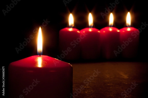 Fototapeta Set of red candles burning in the dark