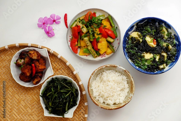 Obraz Vietnamese vegan cuisine, daily meal, seaweed, tofu soup, fried vegetables, dried bread cook with sauce, boiled water spinach