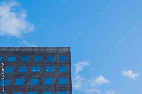 Obraz modern office building with clouds