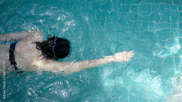Obraz The top view of women is swimming in the swimming pool 