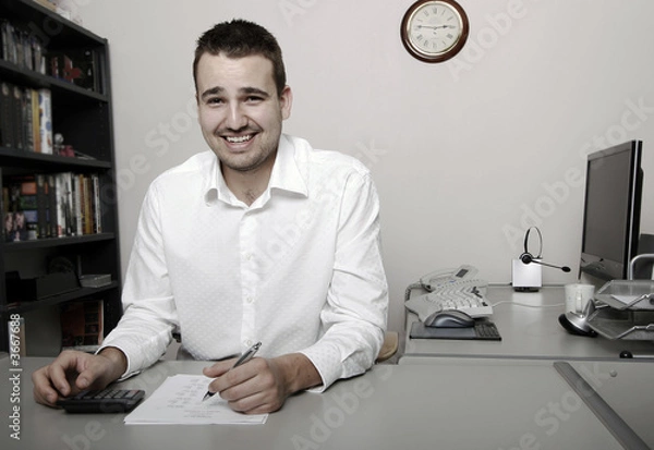 Fototapeta A businessman calculating expenses at tax time