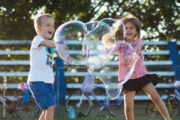 Obraz children playing with soap bubbles
